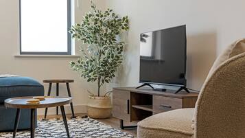 Apartment, City View | Living area | Flat-screen TV