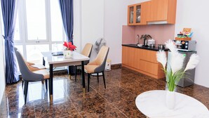 A modern kitchen with wooden cabinets and a built-in microwave. - Cuong Anh House (Ho Chi Minh City)