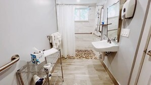 A narrow bathroom with a shower, a sink, and a hand dryer. - Cozy Standard Double Room - Steps to Beach, Free Parking & Pool (Lauderdale by the sea)