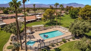 A resort with multiple swimming pools, palm trees, and a mountainous backdrop. - Golf Resort 2BR | Pool, Spa & Pickleball (Palm Desert)
