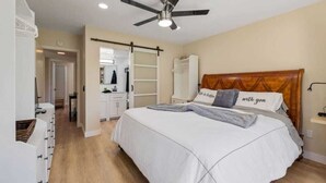 A bedroom with a bed, a ceiling fan, a wardrobe, and a bedside table. - Golf Resort 2BR | Pool, Spa & Pickleball (Palm Desert)