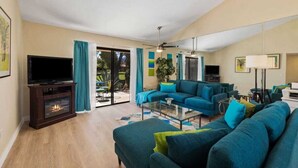 A living room with a fireplace, a television, and a sofa set. - Golf Resort 2BR | Pool, Spa & Pickleball (Palm Desert)