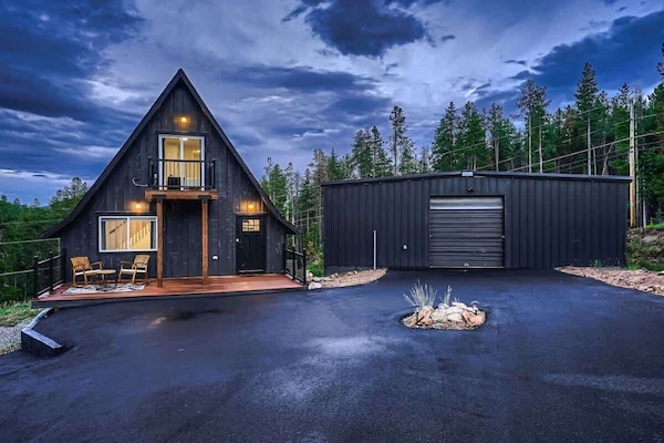 1. Stunning exterior at twilight, showcasing the home’s charm with ample parking space and breathtaking views. The soft glow of the evening sky enhances the inviting atmosphere, while the spacious parking area adds convenience.