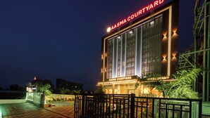 A building with a sign reading "AASMA COURTYARD" and "COFFEE HOUSE" at the entrance. - Treebo Premium Aasma Courtyard (Kujang)