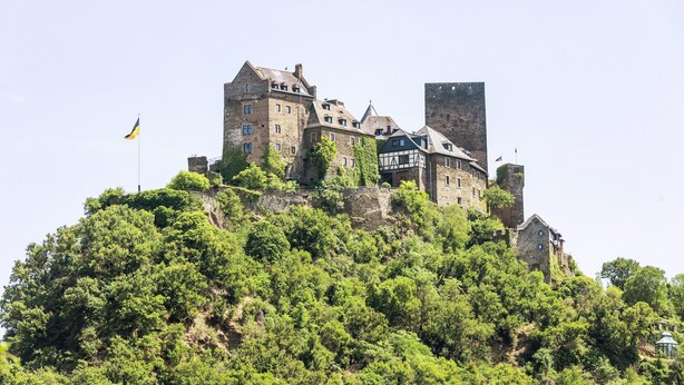 A castle-like structure with multiple buildings, surrounded by dense greenery. - Apartment 'Bubach' with Private Terrace, Shared Garden and Wi-Fi (Bubach)