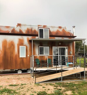 A two-story metal building with a porch, a ramp, and a chimney. - Tiny House Tarana/ O’Connell. Close to Bathurst, Oberon. Peaceful surroundings. (Tarana)