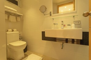 A modern bathroom with a toilet, sink, and glass shelf. - Sea View Beach Bar Beach Front c114 (Rawai)