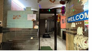 A hotel entrance with a 'WELCOME' sign, a staircase leading inside, and a 'Pay Here' sign. - Hotel M A International (New Delhi)