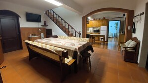 A bedroom with a bed, a desk, and a chair. There is a staircase leading to another room. - Casa Pinto Douro, your vacation home with a breathtaking view.  (Baiao)