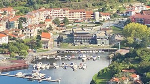 A coastal town with a marina, terraced houses, and a prominent building with a red roof. - Casa Pinto Douro, your vacation home with a breathtaking view.  (Baiao)