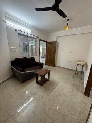 Deluxe Double Room, City View | Living area | Flat-screen TV - White Stone Apartments (Bengaluru)