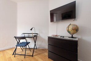 A room with a desk, chair, TV, globe, and a dresser. - Quiet location in Central London, near Paddington, Regent Park, Lord's Cricket (London)
