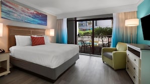 A hotel room with a large bed, a desk, a chair, a TV, and a balcony with a pool view. - Resort View Two Room Condo Family-Friendly (Myrtle Beach)