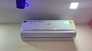 A white air conditioner with a control panel on a wall. - Parel Residency (Mumbai)