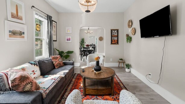A modern living room with a sofa, coffee table, and TV. - Palacio Mexicano (Detroit)