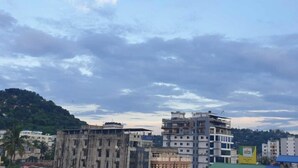 A multi-story building with a flat roof and a flag on top. - Matree Grand Lodge By GRB (Guwahati)