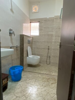 A bathroom with a toilet, sink, and shower.