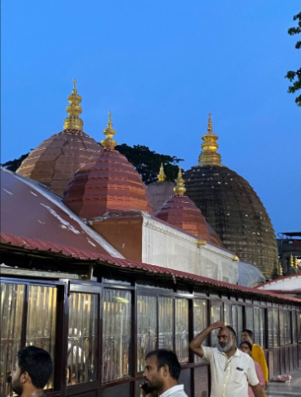 A row of traditional buildings with domed roofs and golden spires, likely part of a historical or cultural site.