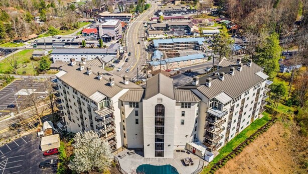 A multi-story building with a central courtyard and a swimming pool.