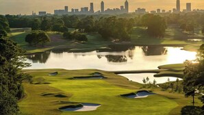 A golf course with a city skyline in the background. - East Lake Escape | Quick Ride to Decatur & Atlanta (Atlanta)