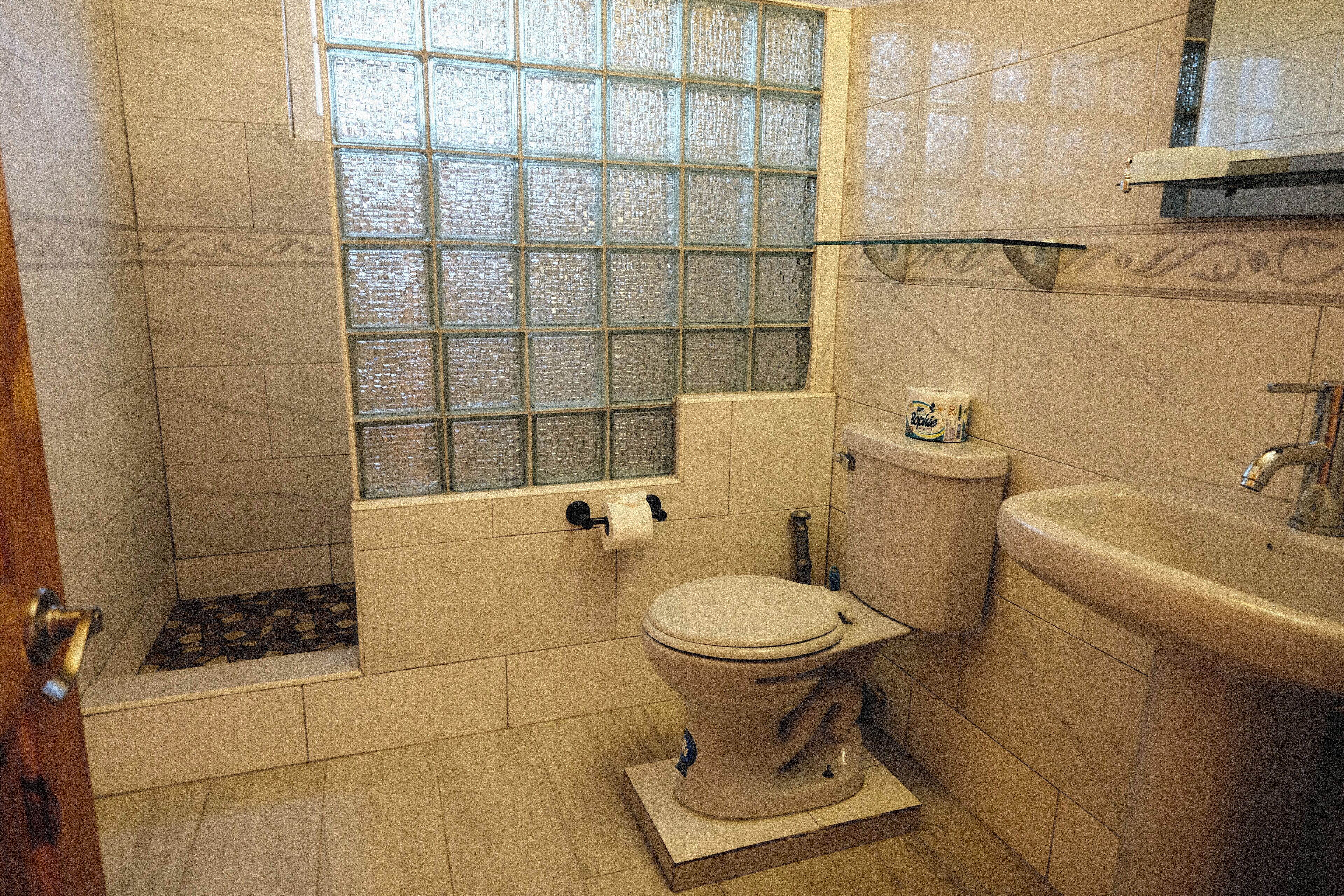 A bathroom with a toilet, sink, and bathtub.