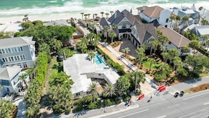 A coastal residential area with houses, a swimming pool, and a view of the ocean. - Loaded 30A Luxury Home! Steps to Beach! LSV, Bikes! Sleeps 22! (Santa Rosa Beach)