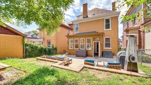 A residential backyard with a patio area, outdoor seating, and a covered outdoor space. - Dog-friendly Pittsburgh Home, 3 Mi to Downtown! (Pittsburgh)