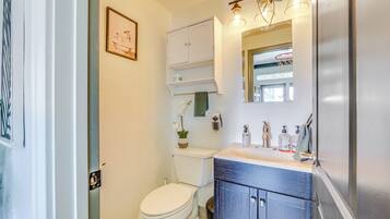 Un baño pequeño con inodoro, lavabo y mueble.