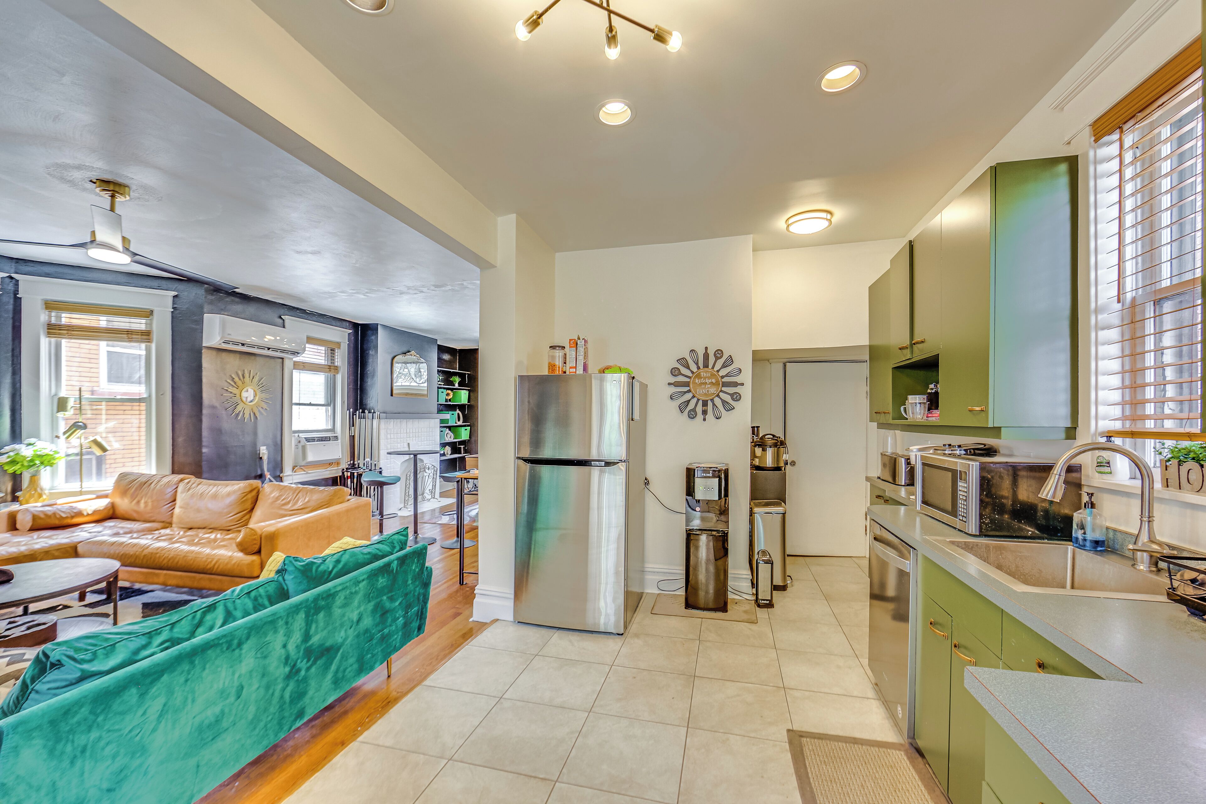 A modern kitchen with a refrigerator, microwave, and sink.