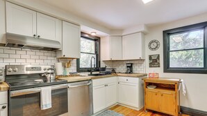 A modern kitchen with white cabinets, stainless steel appliances, and a wooden countertop. - Walk to Mohican Lake: Catskills Getaway w/ Dock! (Glen Spey)