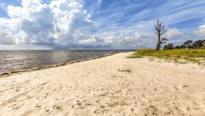 A sandy beach with a clear sky and a few clouds. - Beach & Pool Access: Peaceful St Teresa House (Carrabelle)