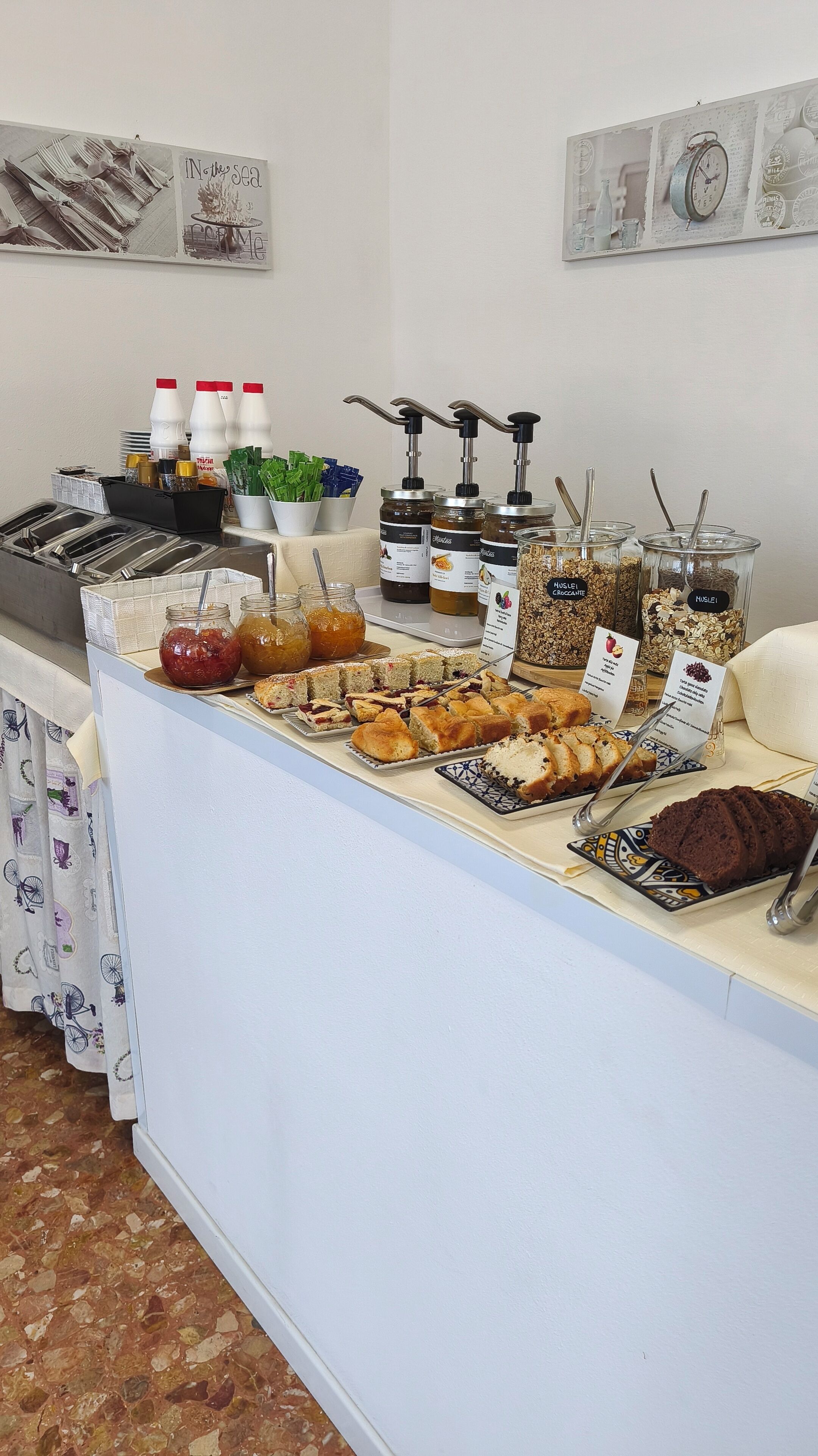 A buffet setup with various food items and condiments.