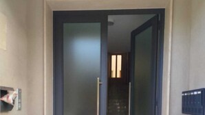 A hallway with a door leading to a staircase.