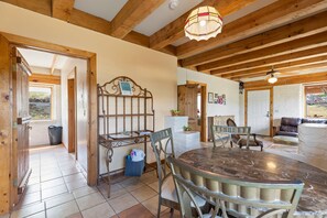 A dining area with a wooden ceiling, a round table, and chairs. - Adobe Vista - Cozy and Inviting Spectacular View (Alpine)