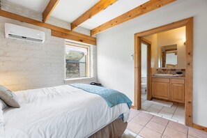 A bedroom with a bed, a window, an air conditioning unit, and a view of the outside. - Adobe Vista - Cozy and Inviting Spectacular View (Alpine)