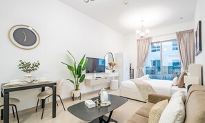 Relax in a spacious room with a comfortable seating area, dining table, and flat-screen TV.