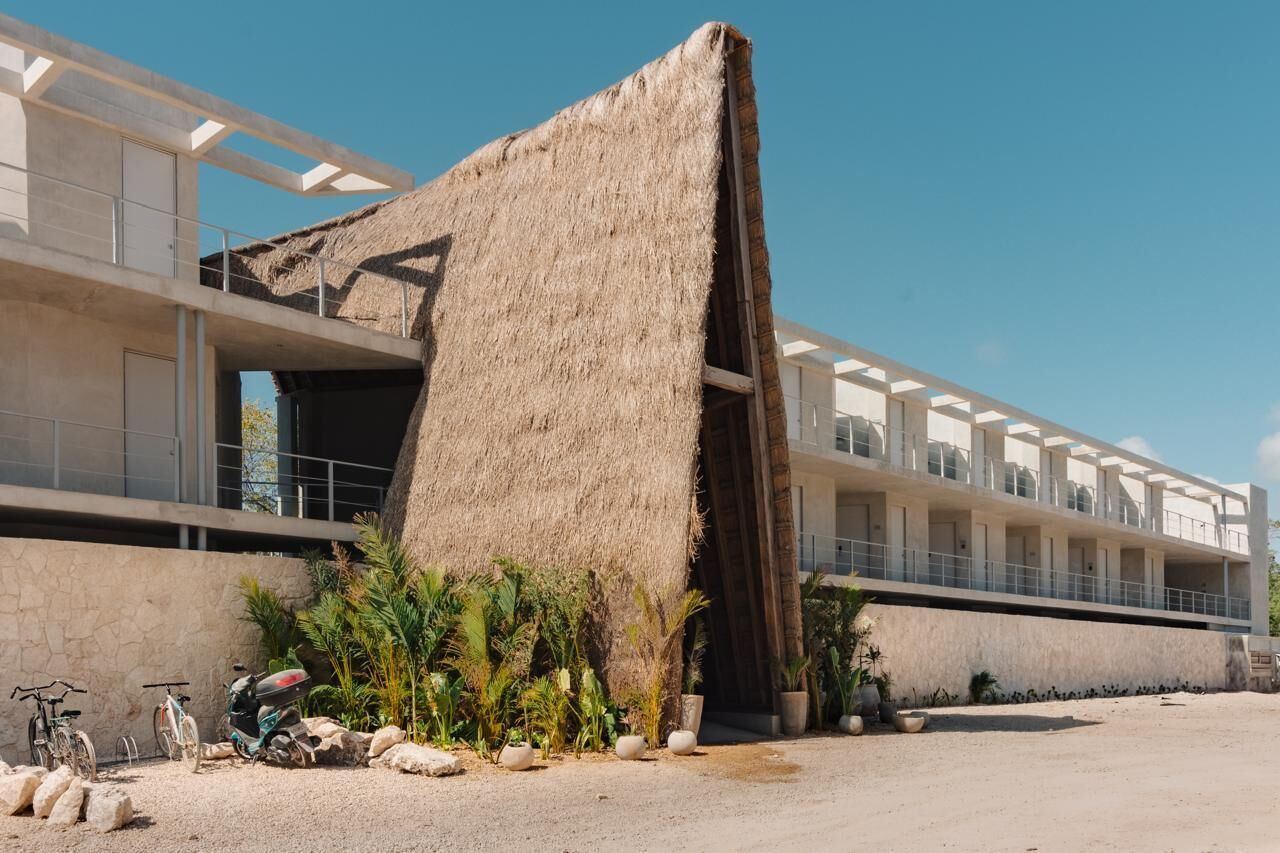 A modern building with a unique thatched structure.