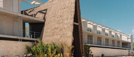 A modern building with a unique thatched structure.