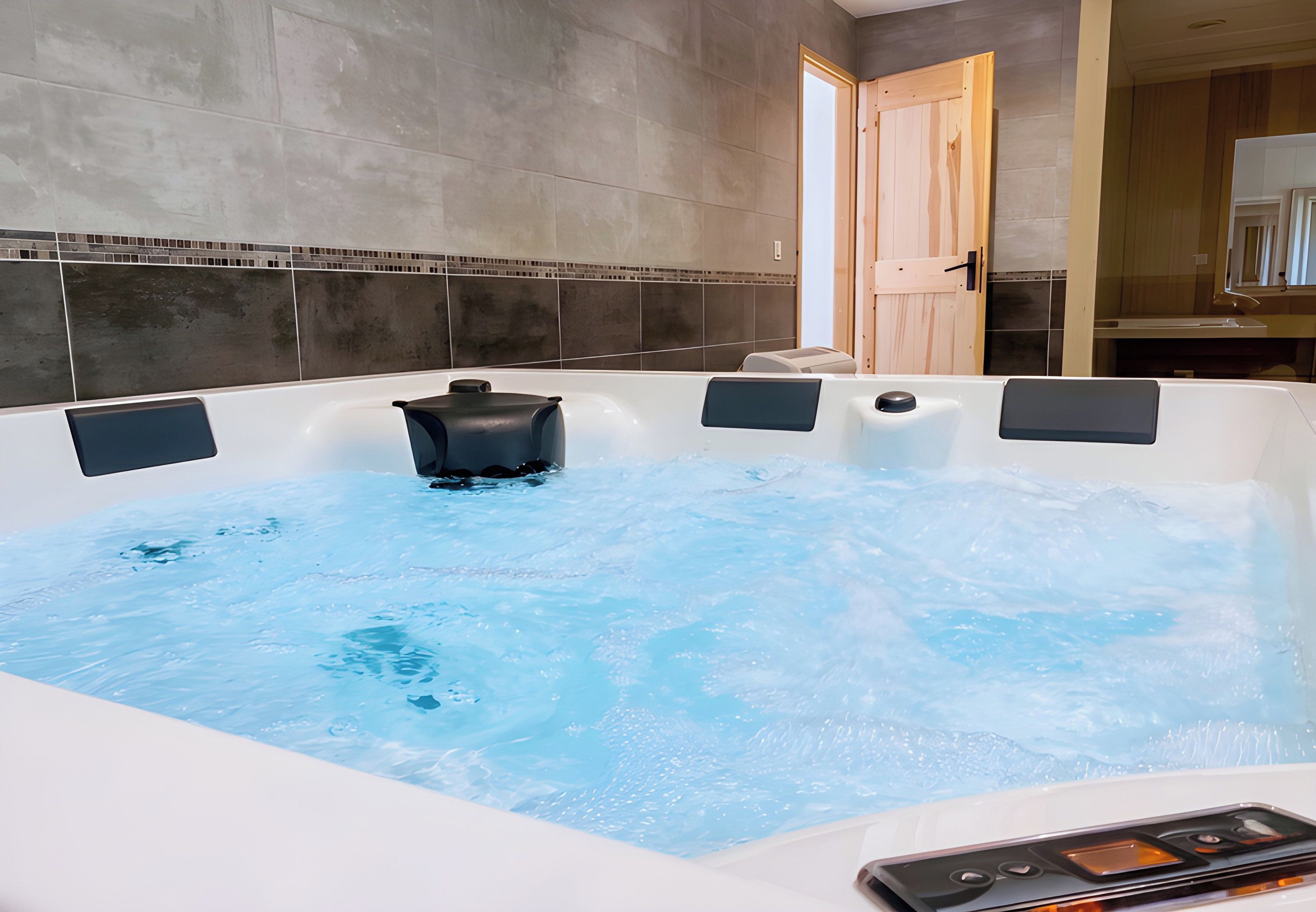 A modern bathroom with a large bathtub, a shower area, and a wooden door.