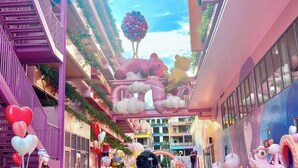 A vibrant indoor atrium with colorful floors, a central fountain, and playful sculptures. - Flamingo Hai Tien  (Hoang Tien)