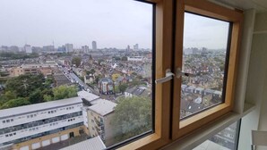 A high-rise building with a large window overlooking a cityscape.