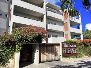 A multi-story building with a sign reading "The Corner Eleven." - Garden view Simpson Bay apartment with pool-GENERATOR (2-1B) (Simpson Bay)