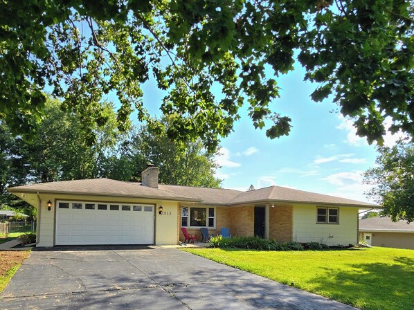 A single-story house with a garage, a front porch, and a well-maintained lawn. - Rockford Cascade Getaway (Rockford)