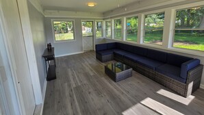 A spacious room with a large window, a ceiling fan, and a built-in bench. - Rockford Cascade Getaway (Rockford)