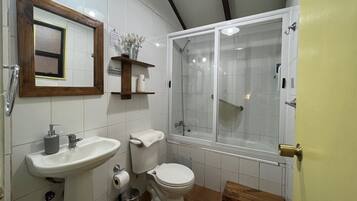 A bathroom with a sink, toilet, and shower.