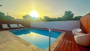 A swimming pool with lounge chairs and a wooden deck. - New Boutique House with Pool near the Beach (Rincón)