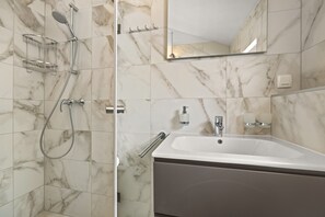 Shower, hair dryer, towels, toilet paper