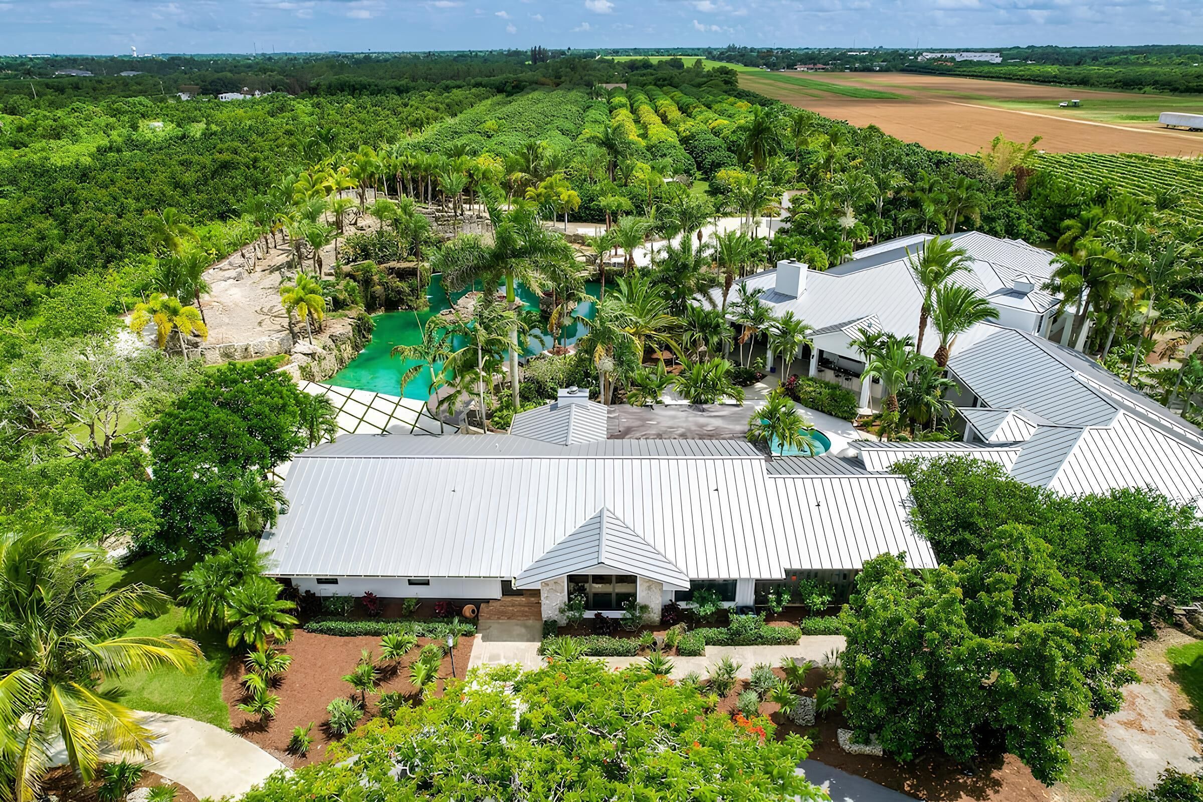 An expansive tropical retreat set amid lush gardens and palm trees