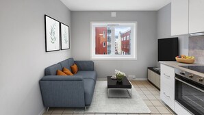 A modern kitchen with a built-in oven, a grey sofa with orange cushions, and a window with a city view. - DOWNToWN KING BED FASHiONABLE (Oslo)