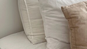A bed with white bedding and a beige pillow. - DOWNToWN KING BED FASHiONABLE (Oslo)